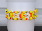 Spooky tumbler bracelet – handmade candy corn beaded wrap in yellow, orange, and white for Halloween drinkware decor.