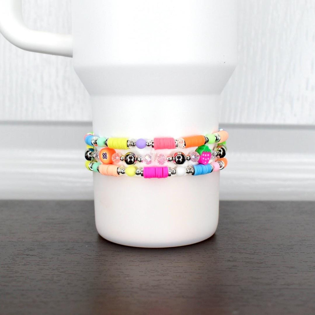 Colorful fruit tumbler bracelet – neon beads with strawberry and pineapple charms for fun summer cup accessories.