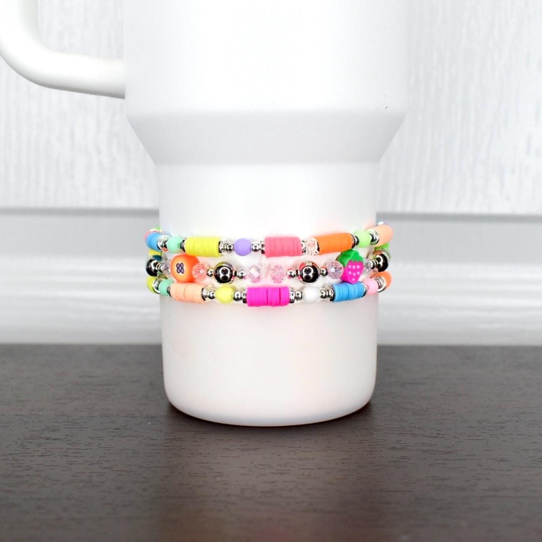 Colorful fruit tumbler bracelet – neon beads with strawberry and pineapple charms for fun summer cup accessories.