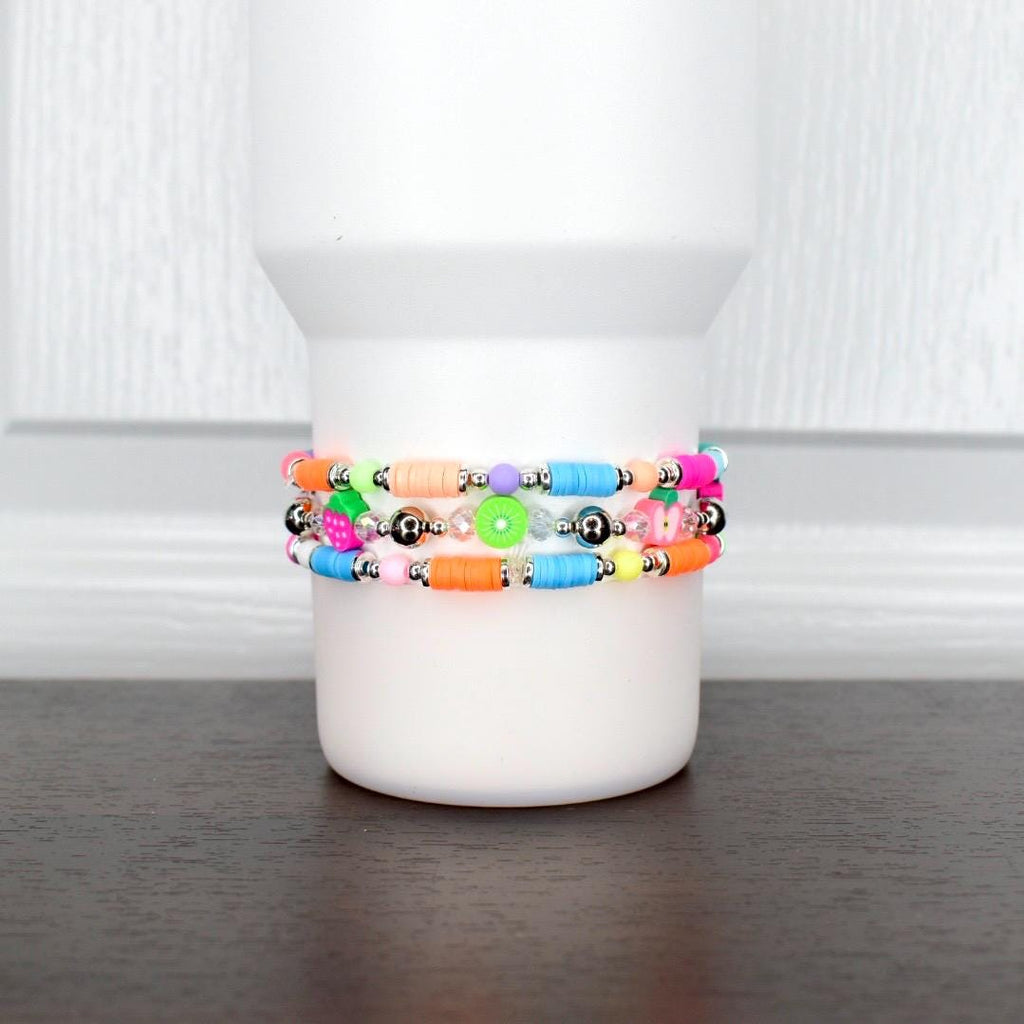 Playful fruity bracelet – neon beaded wrap with bright fruit charms, perfect for summer tumblers or casual wrist jewelry.