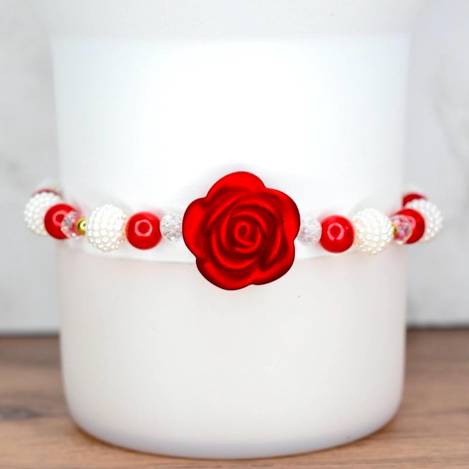 Red rose pearl bracelet with white pearls and red beads displayed on white Stanley tumbler, featuring elastic design for wrist wear or tumbler decoration