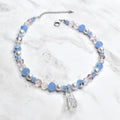 Cinderella inspired necklace for kids with glass slipper pendant, blue beads, silver pearls, and crystal accents on marble background - Disney princess costume jewelry