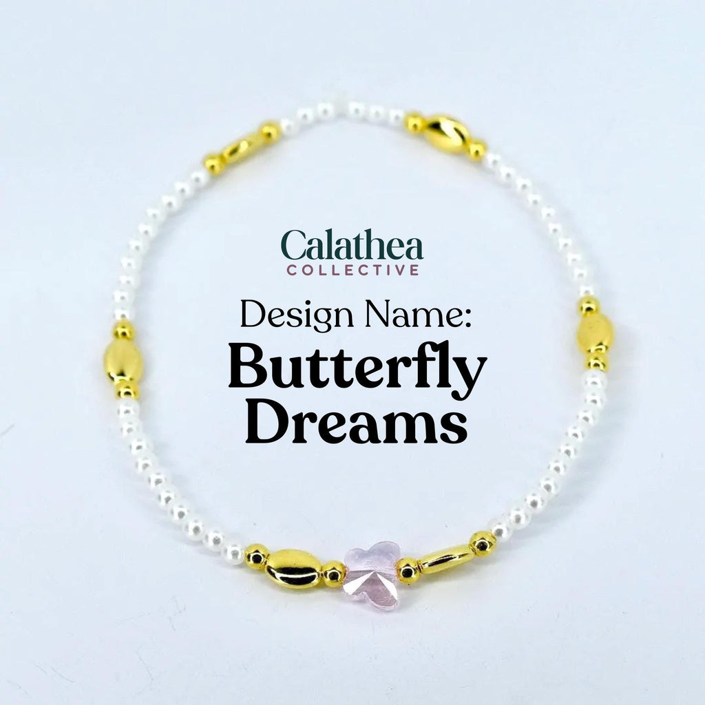 A delicate bracelet featuring small white beads, gold-colored accents, and a pink butterfly charm. The text "Calathea Collective" and "Butterfly Dreams" are displayed on the image.