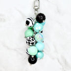 Boho beaded purse charm in turquoise mint black and white with swivel lobster clasp hook flat lay