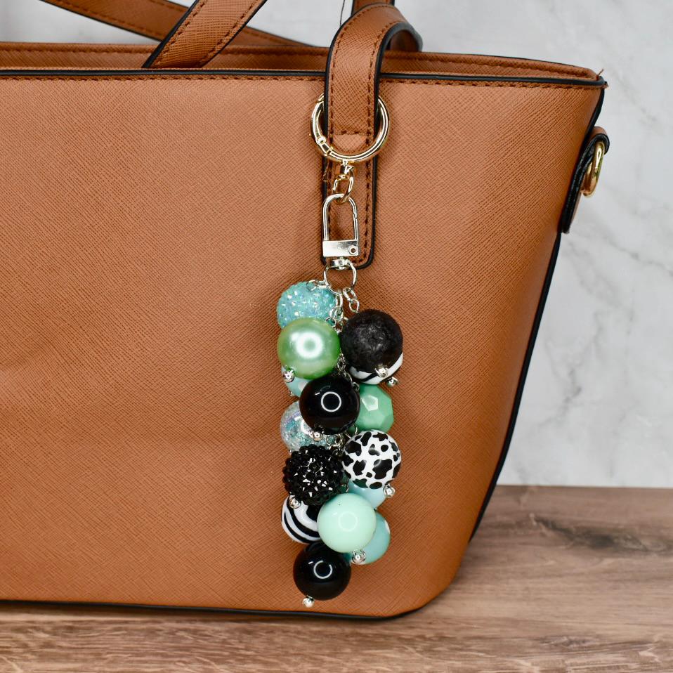 Custom beaded purse charm featuring mint pastel and monochrome beads on lobster clasp hook