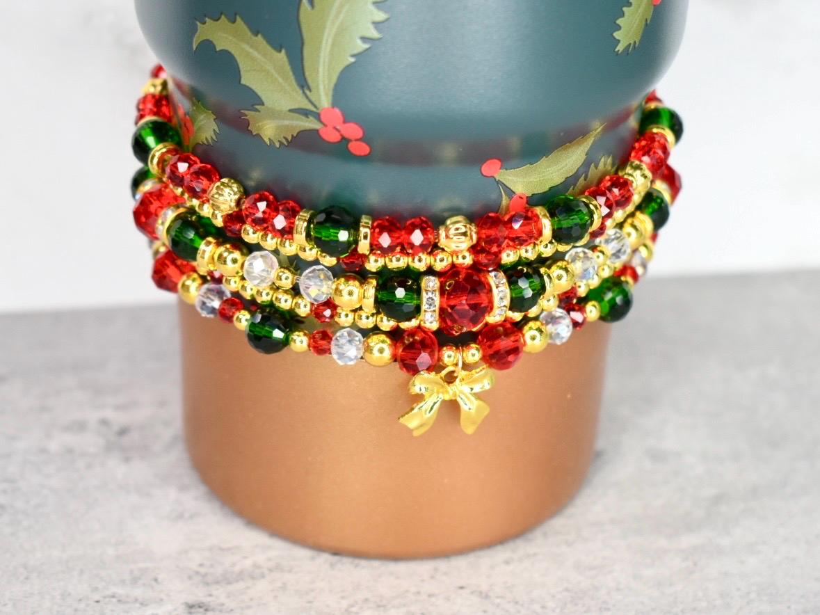 Festive holiday bracelet stack gift idea featuring multi-strand red green gold and silver beads with bow charm handmade jewelry for Christmas