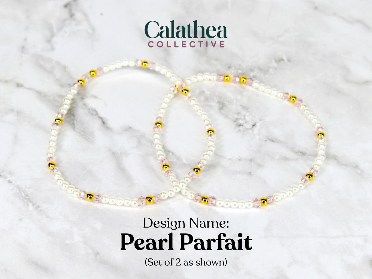 Two delicate pearl bracelets with gold and pink accents. The bracelets are labeled "Pearl Parfait" and are from the "Calathea Collective". The set includes two bracelets as shown.