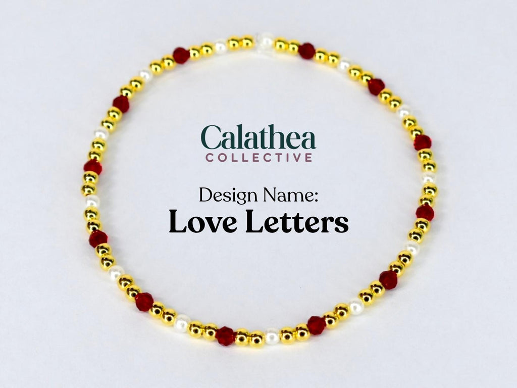 A gold-colored beaded bracelet with red and white beads. The bracelet is circular and features the text "Love Letters" and the Calathea Collective logo.