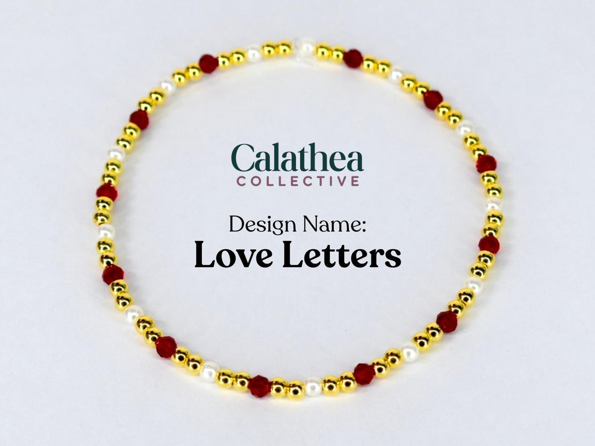A gold-colored beaded bracelet with red and white beads. The bracelet is circular and features the text "Love Letters" and the Calathea Collective logo.