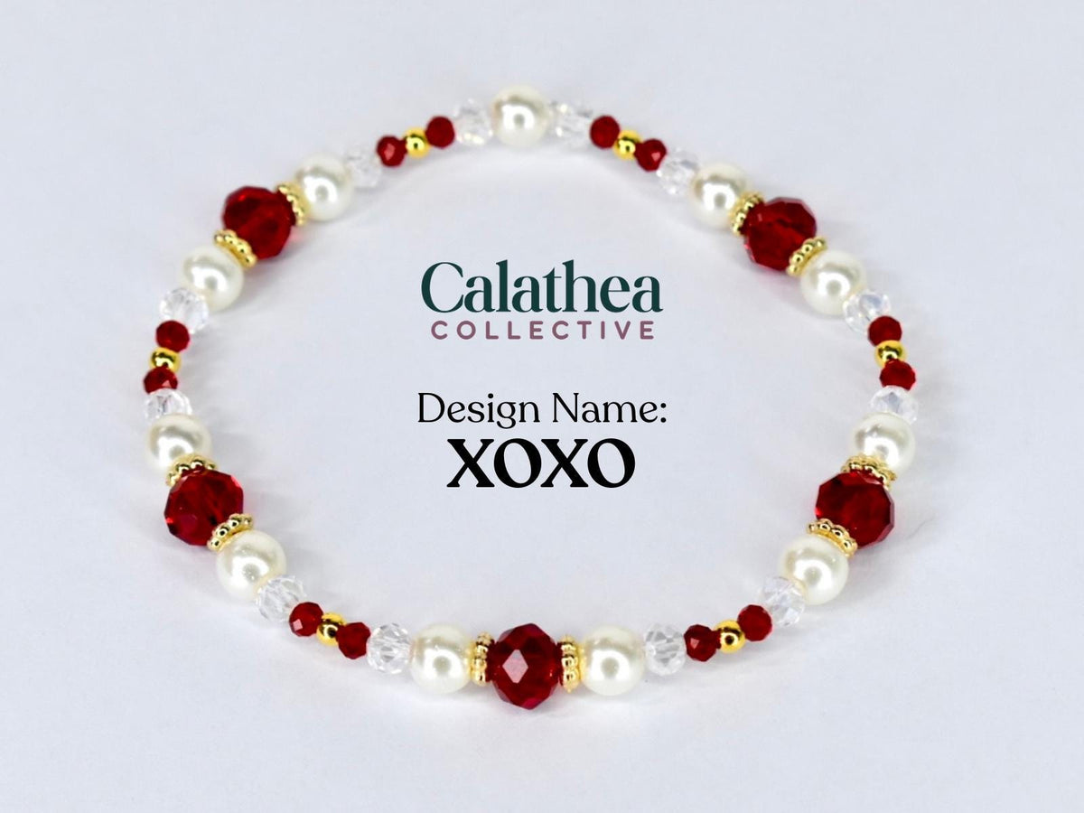 A beaded bracelet featuring alternating white faux pearls, faceted red beads, and small gold-colored beads. The bracelet is labeled "Design Name: XOXO" and includes the "Calathea Collective" logo.