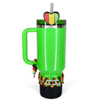A bright green tumbler with a handle, adorned with a heart-shaped topper in the colors of the Pan-African flag. The tumbler is decorated with beaded bracelets and the words "Celebrate Black History".