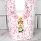 Coquette Bow Stanley tumbler with pink faux pearl and crystal handle charm with a gold bow and tear drop sparkling gem drop charm.
