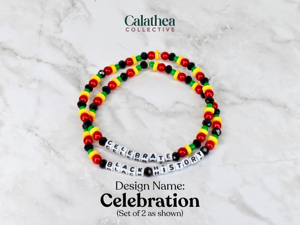 Two beaded bracelets with red, yellow, black, and green beads. One bracelet spells out "CELEBRATE" and the other "BLACK HISTORY" in white letter beads. The design name is "Celebration".