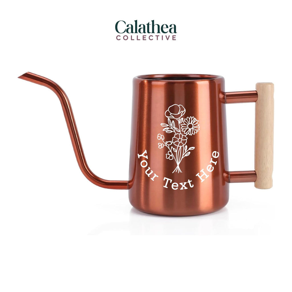 A copper watering can with long gooseneck spout and wood handle with a white flower bouquet design and 'your text here' below the bouquet in white permanent vinyl.