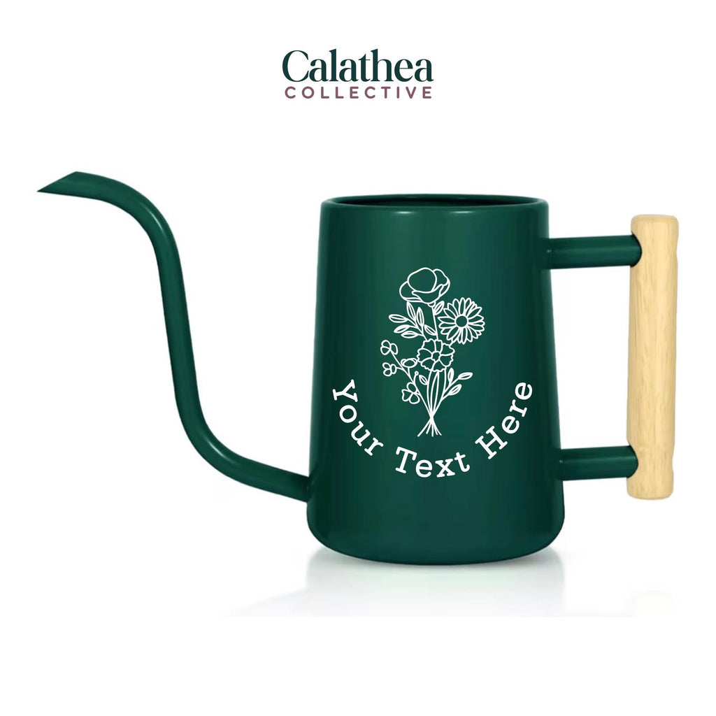 An emerald green watering can with long gooseneck spout and wood handle with a white flower bouquet design and 'your text here' below the bouquet in white permanent vinyl.