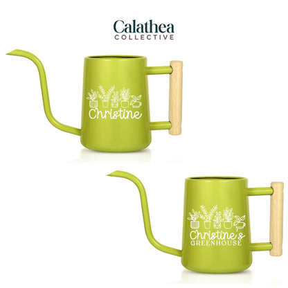 Two green watering cans with a long spout and wooden handle. The cans have white text that reads "Christine" and "Christine's Greenhouse" with plant illustrations. The brand name "Calathea Collective" is at the top.