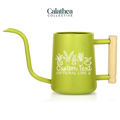 A lime green watering can with a long, slender spout and a wooden handle. The can features a white graphic of potted plants and the text "Custom Text Optional Line 2". The logo "Calathea Collective" is at the top.