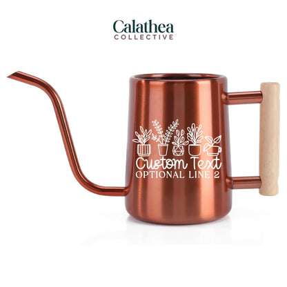 Copper-colored watering can with a long, curved spout and a wooden handle. The can features a white graphic of potted plants and the text "Custom Text Optional Line 2". The watering can is designed for indoor plant care.
