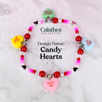 A single bracelet with red, pink, and crystal beads and four conversation heart charms around the bracelet. In the center, the design name 'candy hearts' is shown.