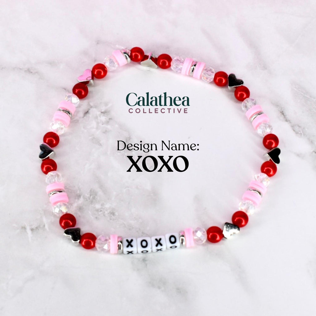 A single bracelet with red and pink beads and letter beads spelling XOXO in the bottom center of the image. The center of the photo shows the design name 'XOXO.'