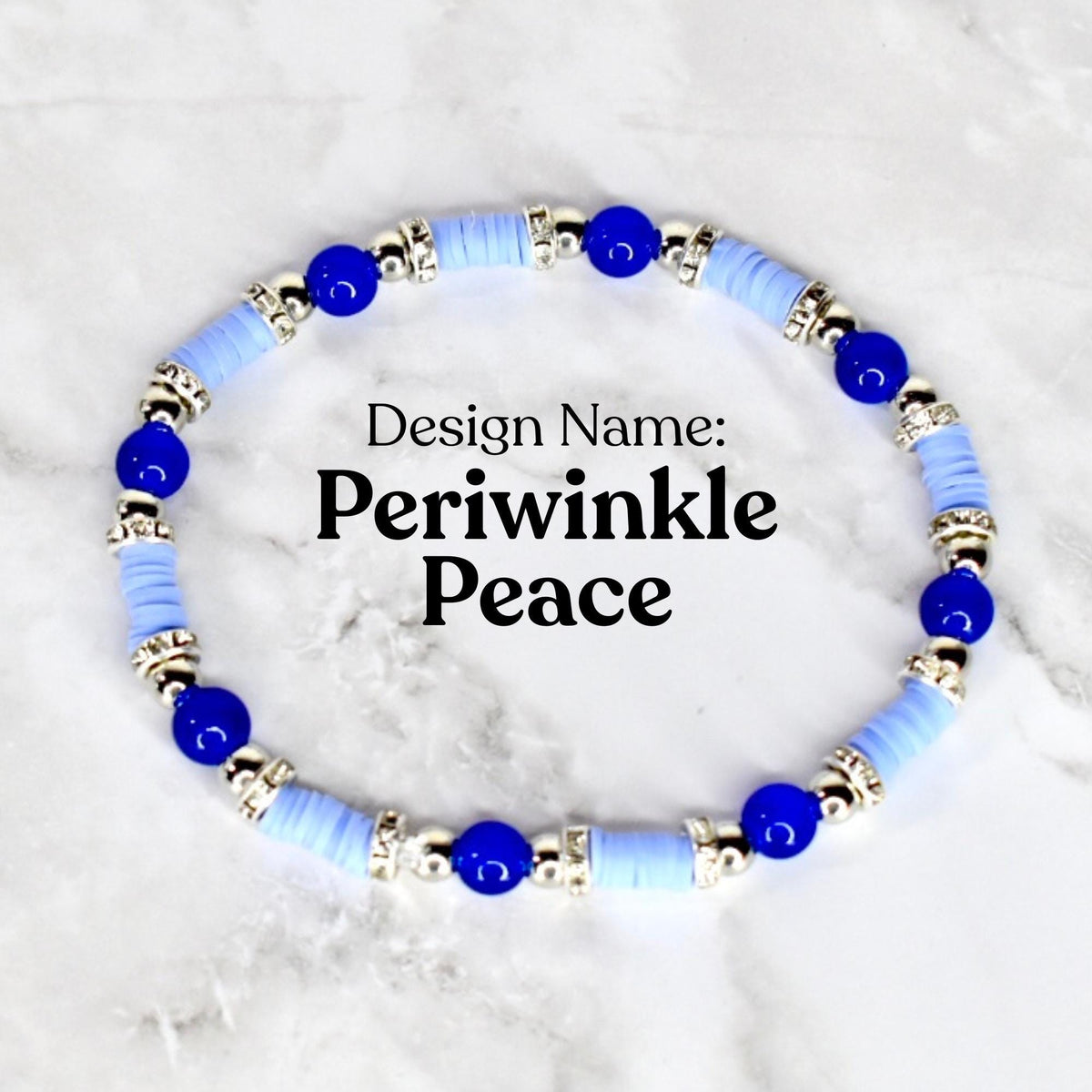 A bracelet with the design name "Periwinkle Peace". The bracelet features light blue disc-shaped beads, interspersed with dark blue spherical beads and silver-colored decorative elements. The bracelet is displayed on a white surface.