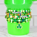 Shamrock Beaded Bracelet Irish Charm Jewelry Holiday Accessory Green Gold Design Festive Colors Elastic Band Lucky Clover Pattern Celebration Wear Stacking Bracelets Collection Festive Outfit Addition March Holiday Tradition Tumbler