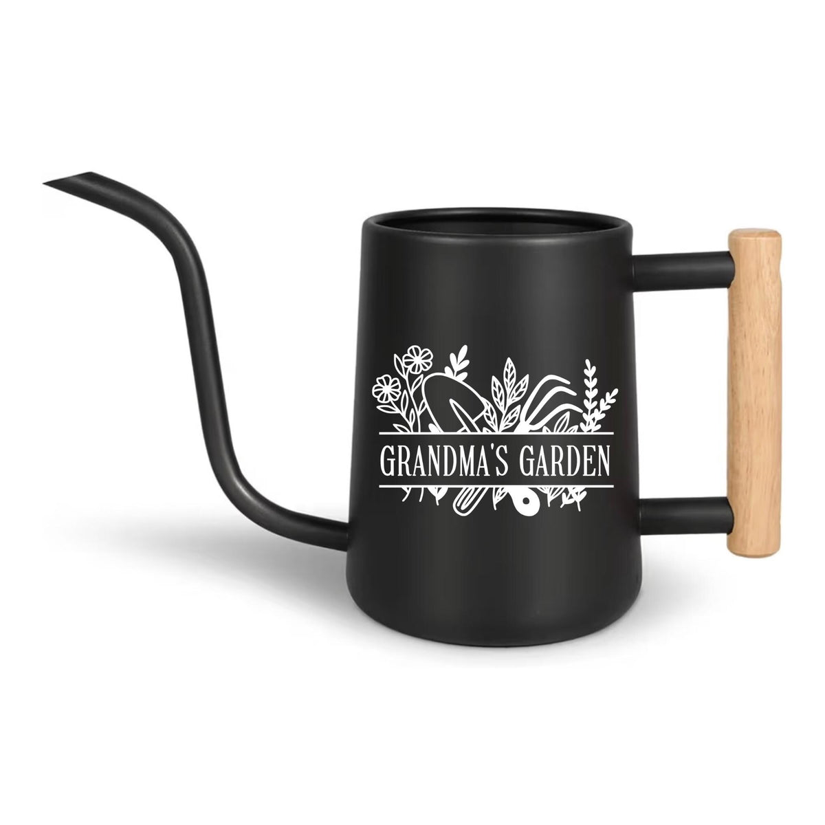 Black metal watering can with a long, curved spout and a wooden handle. The can features the text "Grandma's Garden" in white, along with floral and gardening tool illustrations. The handle is made of light-colored wood.