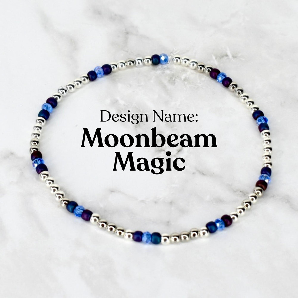 A delicate beaded bracelet featuring small silver beads interspersed with blue and purple beads. The text "Design Name: Moonbeam Magic" is displayed in black font.