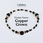 A beaded bracelet with the text "Copper Crown." The bracelet features black, clear, silver, and copper-colored beads. The bracelet is from the Calathea Collective.