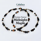 Two beaded bracelets with the text "Design Name: Midnight Maple". The bracelets feature black, clear, and copper-colored beads, including heart-shaped accents. The bracelets are on a white background.