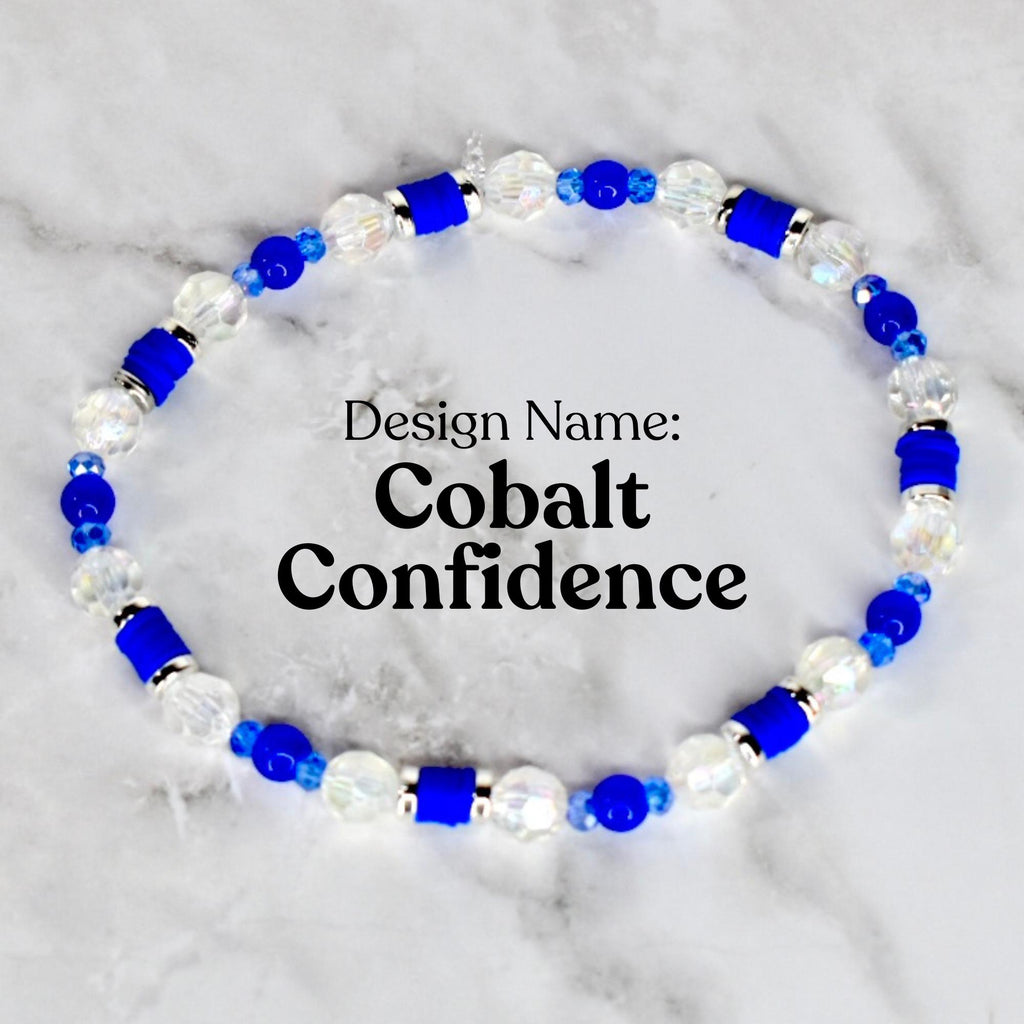A beaded bracelet with the design name "Cobalt Confidence." The bracelet features a combination of clear, faceted beads, cobalt blue beads, and cylindrical cobalt blue accents. The beads are strung together to form a circular shape.