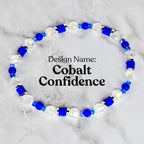 A beaded bracelet with the design name "Cobalt Confidence." The bracelet features a combination of clear, faceted beads, cobalt blue beads, and cylindrical cobalt blue accents. The beads are strung together to form a circular shape.