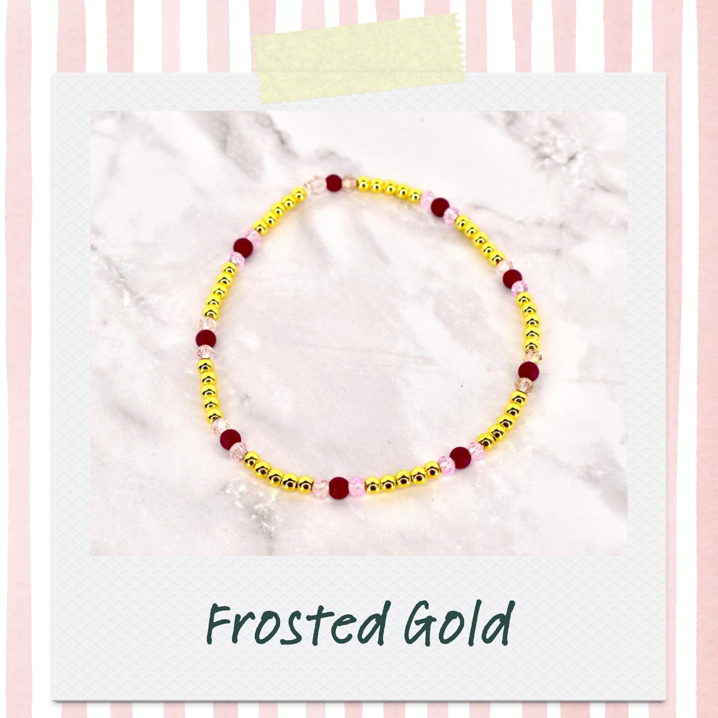 A beaded bracelet with gold beads, interspersed with burgundy and pink beads. The bracelet is displayed on a white surface, with the words "Frosted Gold" in a script font at the bottom.