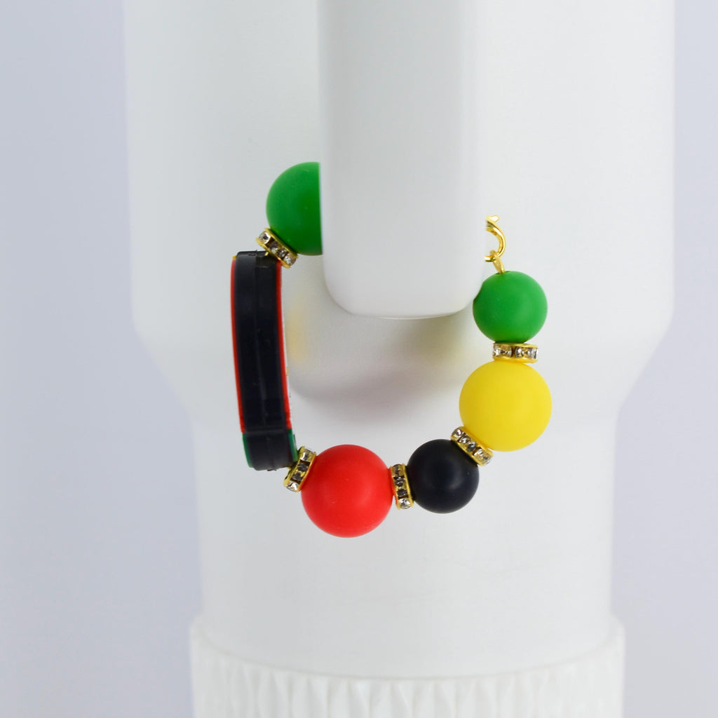 A colorful handle bracelet with a gold-colored hook. The bracelet features a combination of green, yellow, red, and black beads, accented with gold-colored rhinestone spacers. A black and red rectangular element is also included.