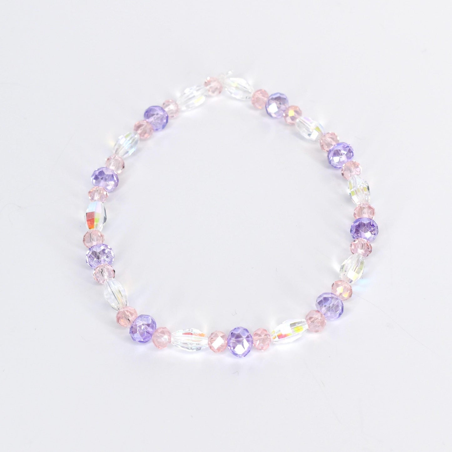 A delicate bracelet featuring a mix of clear, iridescent, and pastel-colored beads. The design incorporates oval and round beads in shades of pink and purple, creating a subtle, feminine accessory.