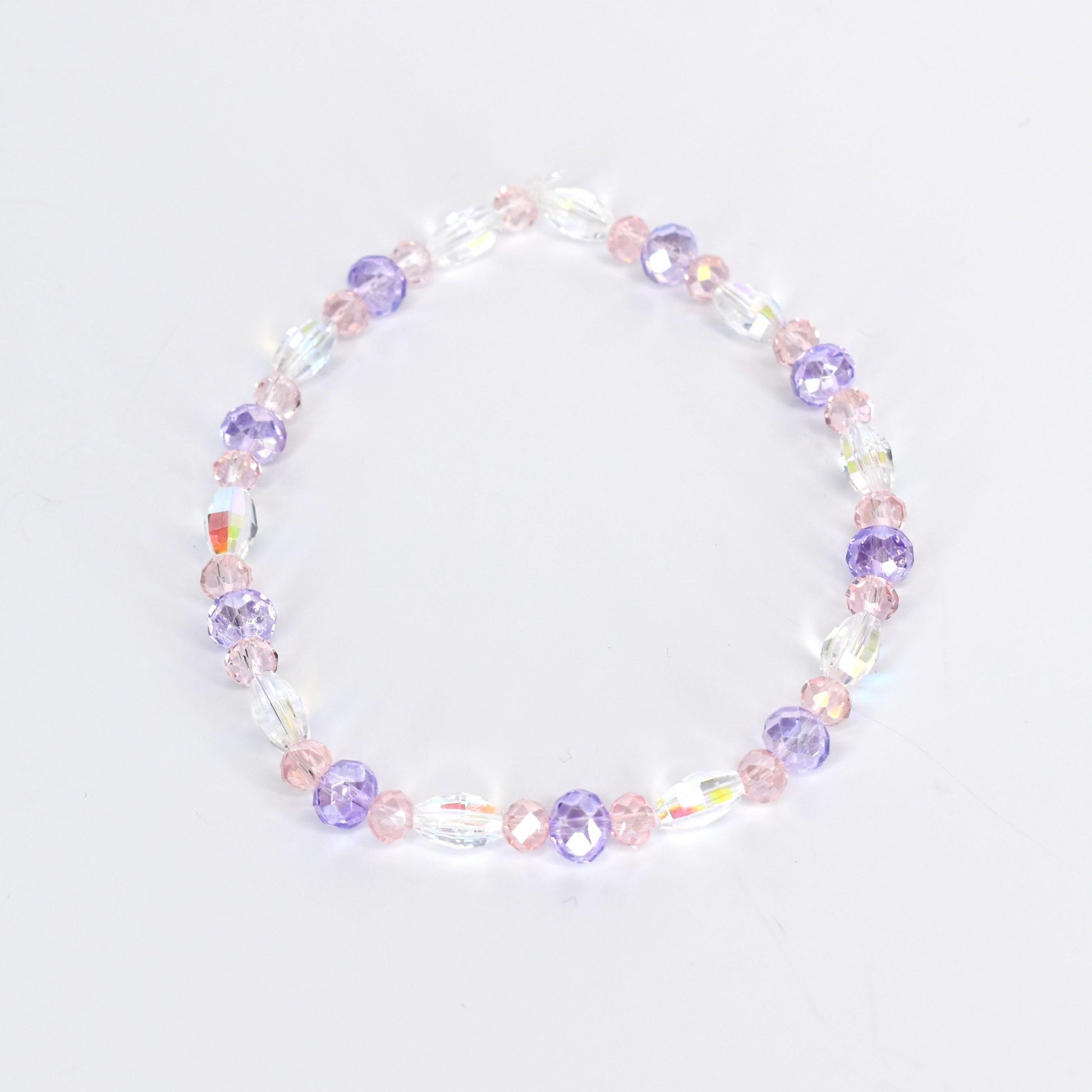 A delicate bracelet featuring a mix of clear, iridescent, and pastel-colored beads. The design incorporates oval and round beads in shades of pink and purple, creating a subtle, feminine accessory.