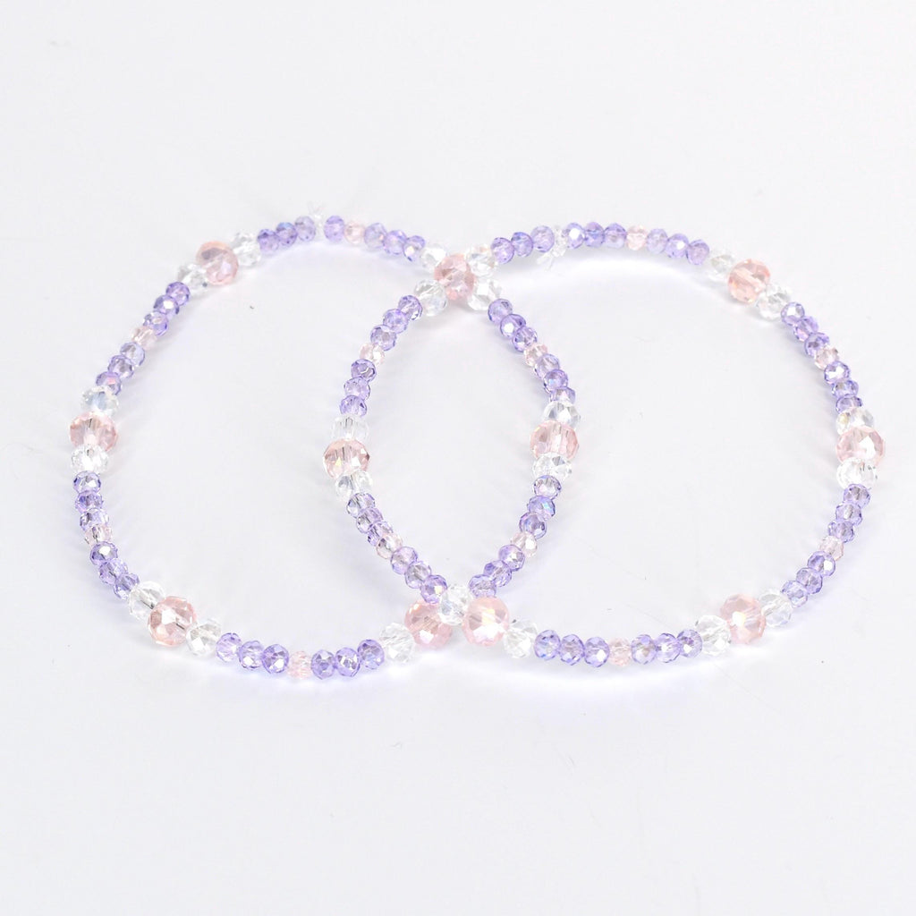 Two beaded bracelets. Each bracelet is a circle of small, light purple, clear, and pink beads. The bracelets are on a white background. The beads are strung together with a clear string.