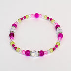 A beaded bracelet featuring a mix of pink, clear, and light green beads. The bracelet includes larger, round magenta beads, clear faceted beads, and smaller green and clear beads. Silver-colored spacers are interspersed throughout.