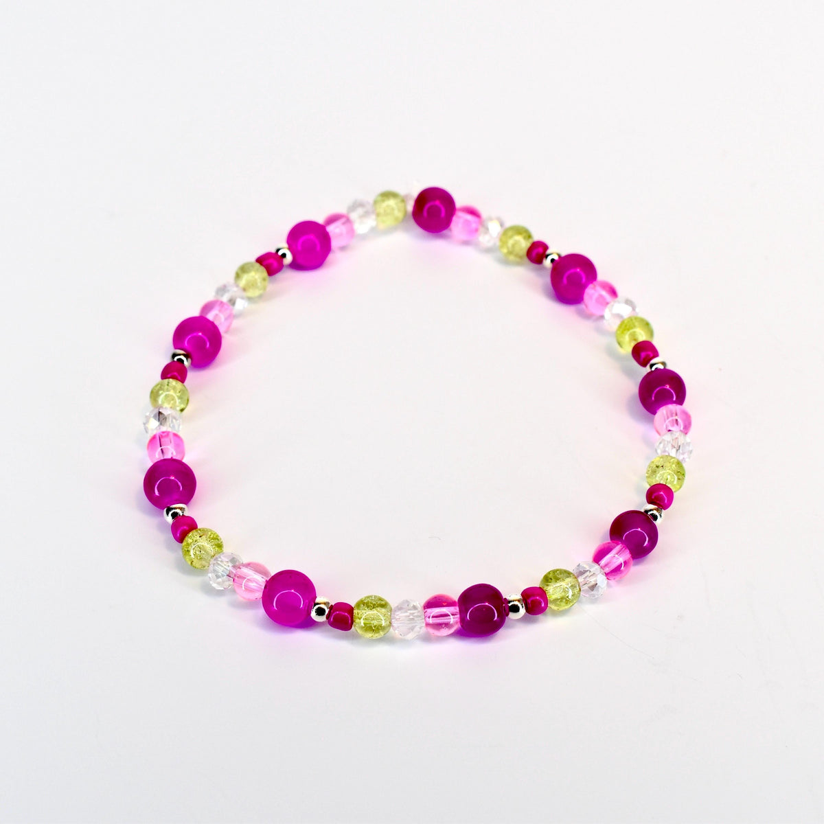 A beaded bracelet featuring a mix of vibrant colors. The bracelet includes large, round magenta beads, interspersed with smaller, clear, and light green beads. The beads are strung together with a silver-colored string, creating a colorful accessory.