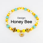 Yellow and mint honey bee charm bracelet with gold bee charms, enamel daisy charm, yellow and white striped beads, flower beads and matte seafoam green round beads – handmade bee themed jewelry
