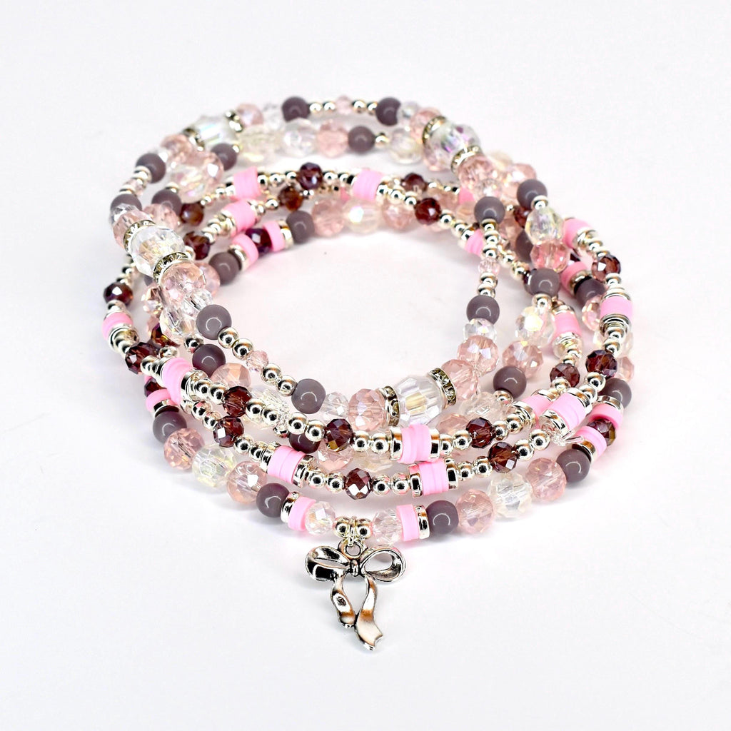 A set of five beaded bracelets with a speckled, matte finish. The bracelets are in shades of light pink, purple, and clear.