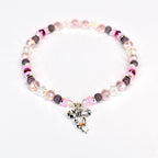 A beaded bracelet featuring a silver bow charm. The bracelet has a mix of pink, clear, and dark purple beads. The bow charm is detailed and adds a touch of elegance to the jewelry.