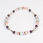 A delicate bracelet featuring a mix of clear, pink, and purple beads. The bracelet includes faceted crystal beads, round purple beads, and small silver-colored spacer beads. The design is strung together, creating a flexible and elegant accessory.