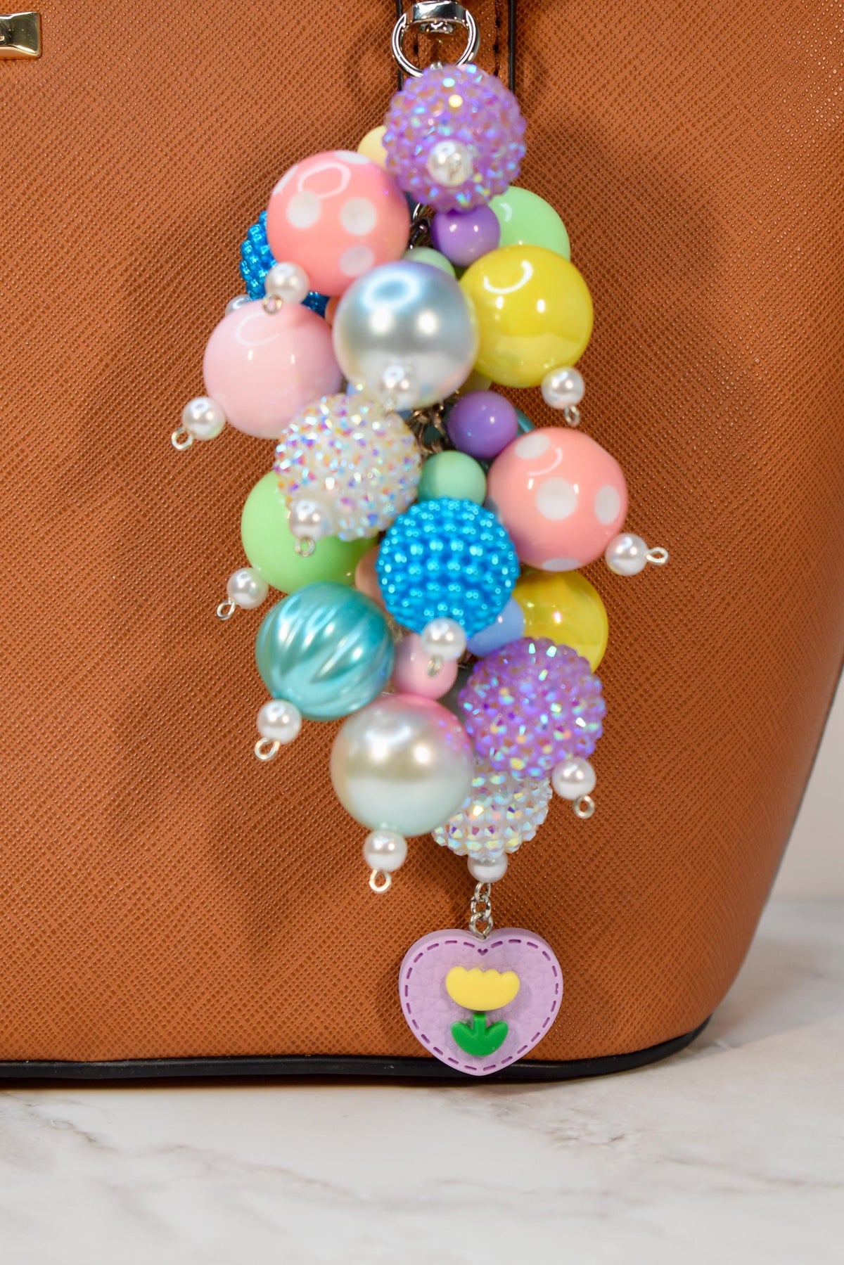 Colorful pastel beaded purse charm featuring mixed glossy and textured beads with pearl details and floral heart pendant. Handmade bag charm and keychain accessory, perfect as a spring gift, Easter accessory, or cute handbag charm.