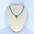 Handmade turquoise beaded necklace with delicate silver bow charm – feminine summer jewelry.