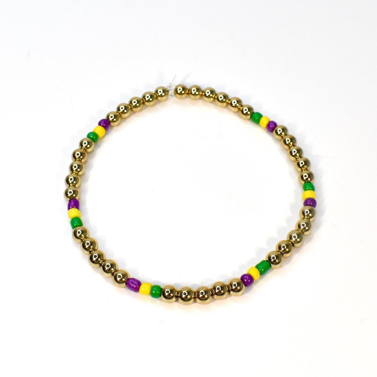 Gold beaded bracelet with alternating sections of purple, yellow, and green beads. The bracelet is made of small, round gold beads, with the colorful beads interspersed throughout. The bracelet is displayed on a white background.
