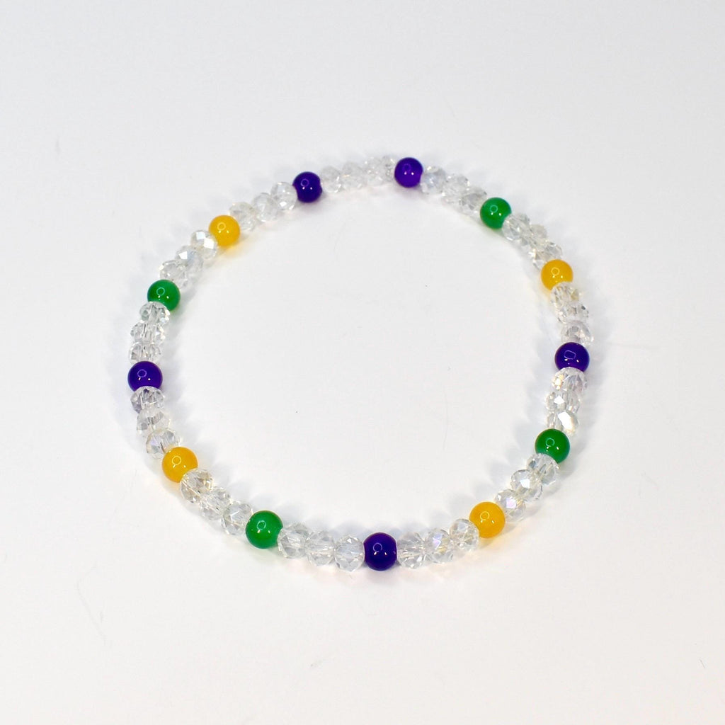 A clear beaded bracelet with alternating colored beads. The bracelet features clear faceted beads interspersed with yellow, green, and purple beads. The bracelet is displayed on a white background.
