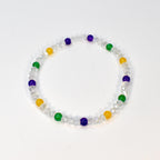 A clear beaded bracelet with alternating colored beads. The bracelet features clear faceted beads interspersed with yellow, green, and purple beads. The bracelet is displayed on a white background.