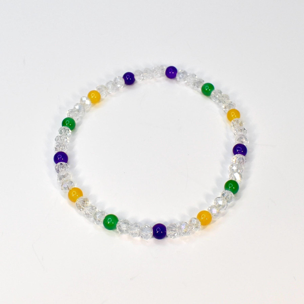 A clear beaded bracelet with alternating colored beads. The bracelet features clear faceted beads interspersed with yellow, green, and purple beads. The bracelet is displayed on a white background.