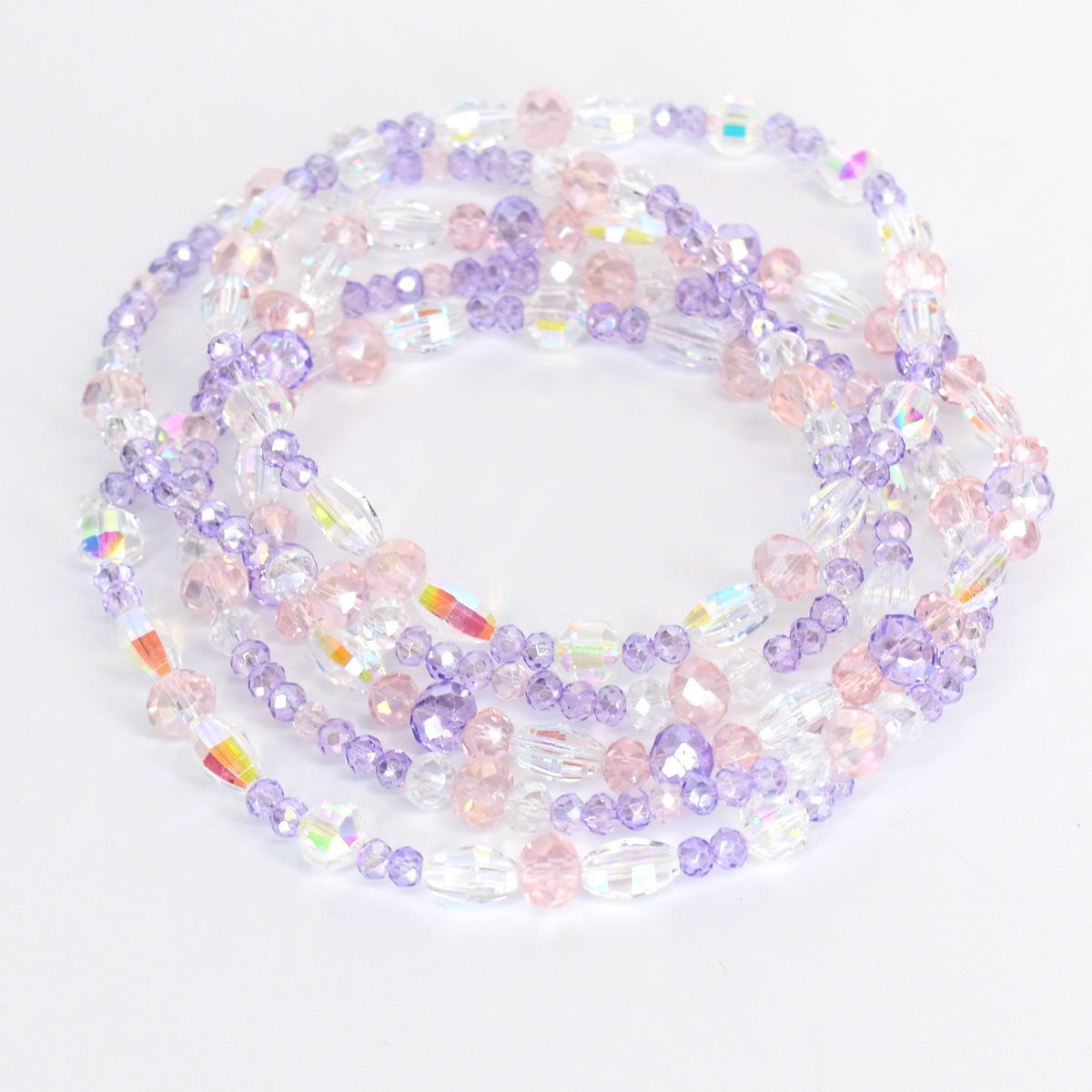 Strands of beaded jewelry in shades of clear, pink, and lavender. The beads are various shapes and sizes, including round and oval. The jewelry is arranged in a circular pattern, with the beads reflecting light.